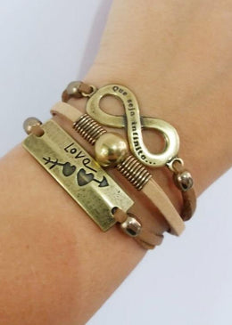 Pulseira Infinito - Love. DESCRIÇÃO DO PRODUTO:Marca: FEITO A MÃO BIJUTERIAS FINASMateriais:  couro sintético tipo camurça nas cores rose e marrom, metais banhados na cor ouro velho,... 