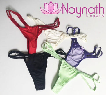 Kit Tanga 5 PEÇASKit com 5 tangas com aviamento preto tecido estampado ou com cores lisas,tamanho único ! Composição: 90% Poliéster 10% Elastano Forro 100% Algodão. 